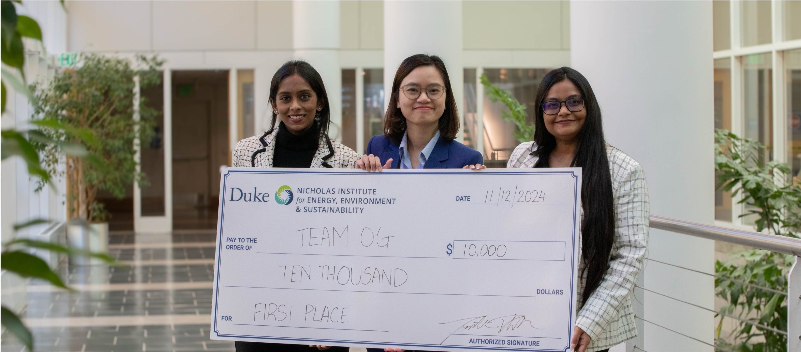 A group of women holding a large check.